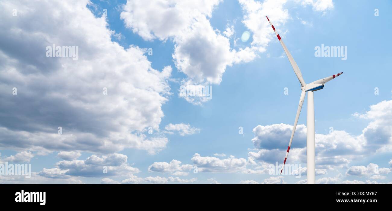 Wind turbine against blue sky Stock Photo - Alamy