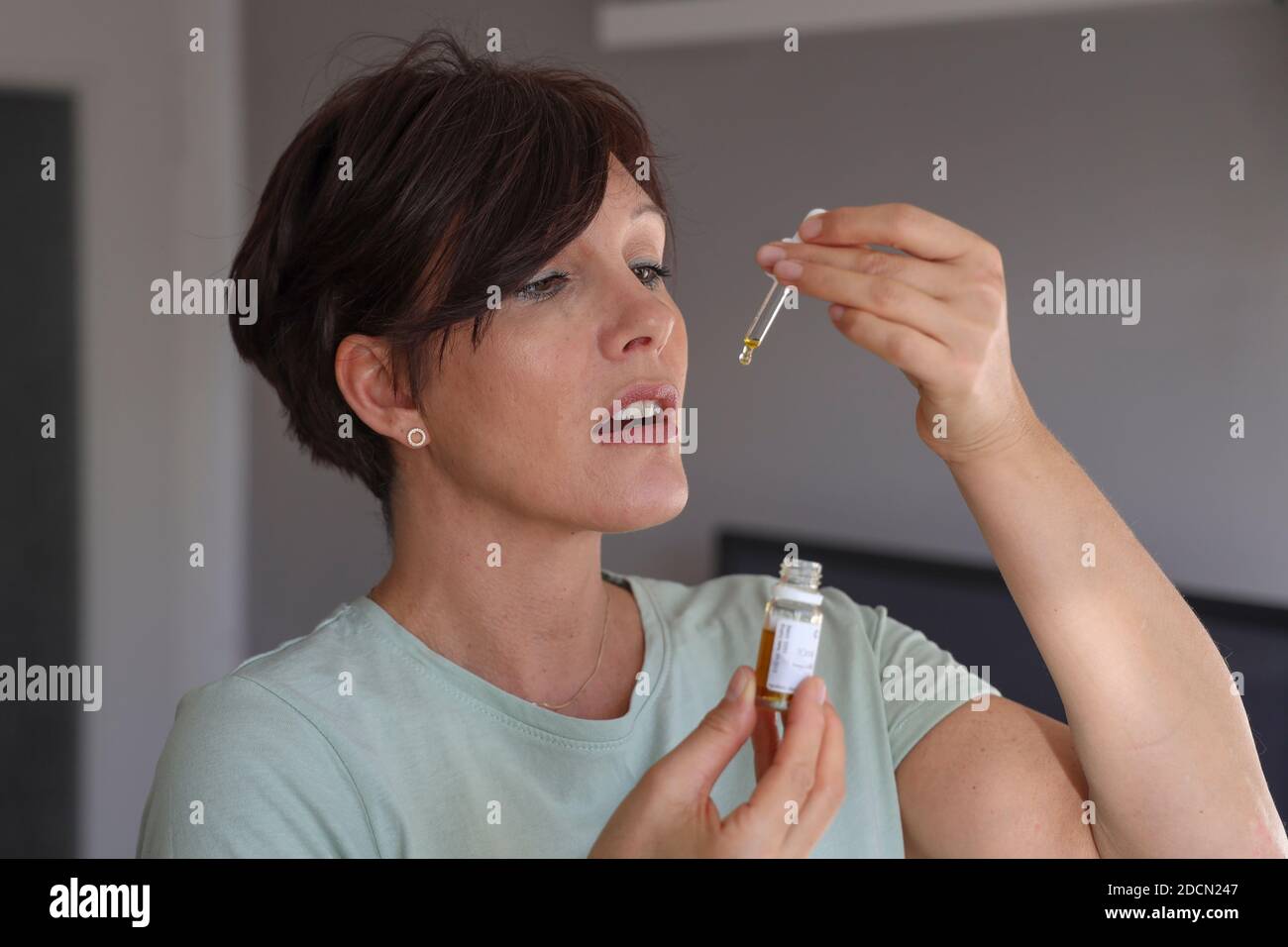 Woman using CBD oil Stock Photo