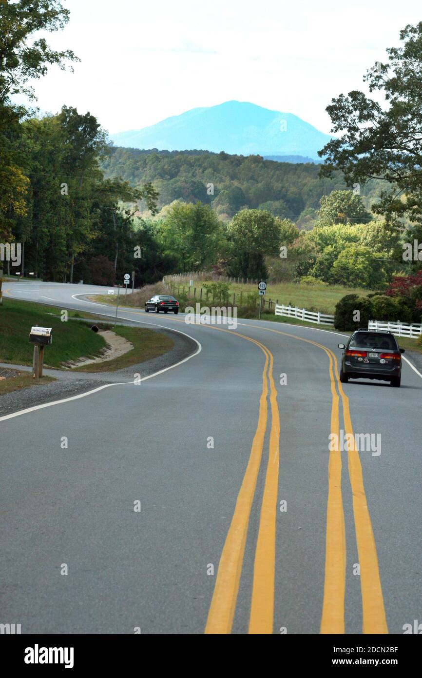 Scenic country road in Virginia, USA, with two sets of double yellow marking lines Stock Photo