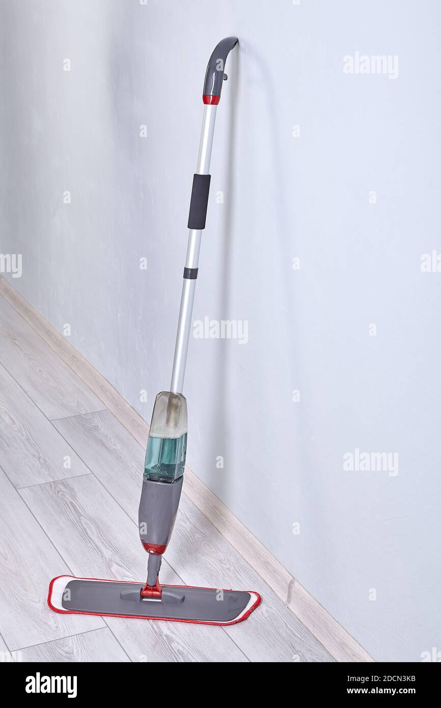 Cleaning tool for wet mopping of floors. Spray mop with builtin water