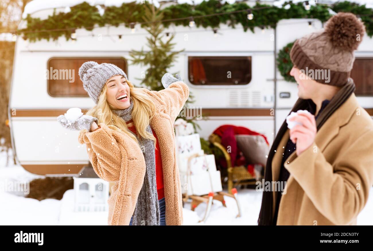 Winter Pastime. Young Cheerful Couple Having Fun Together Outdoors At Campsite Stock Photo
