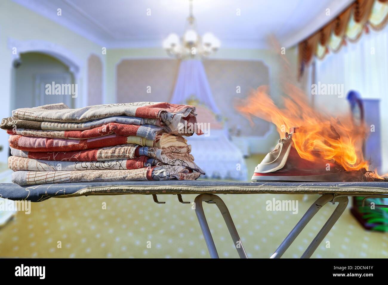 An iron forgotten not turned off caused a fire in the living room. Stock Photo