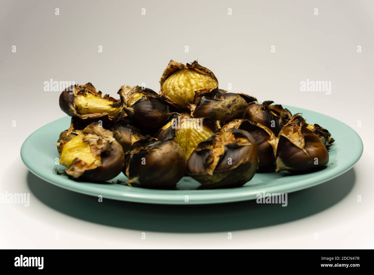 Chestnuts cooked on fire in a plate Stock Photo