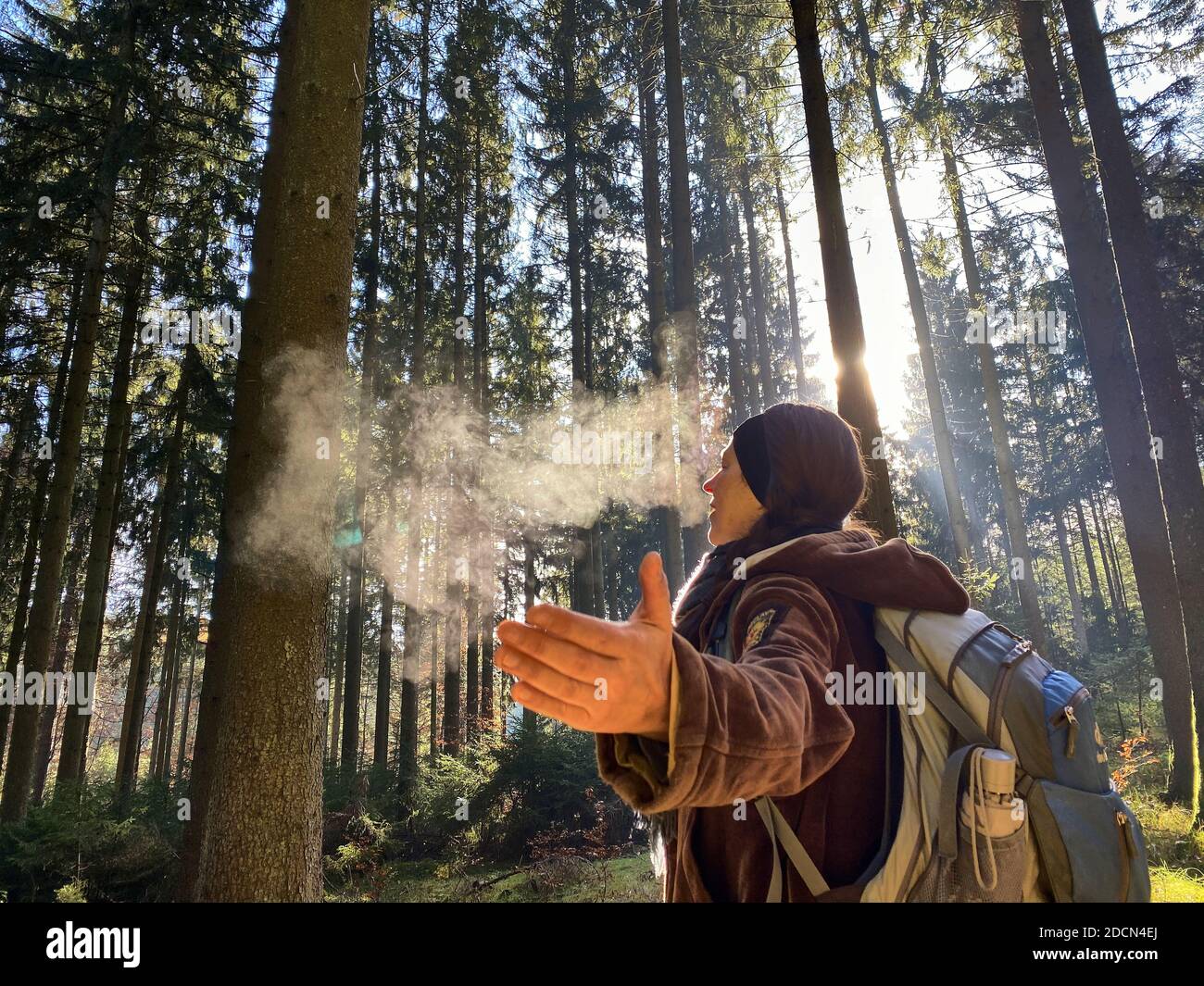 A woman is walking through the forest in autumn, forest bathing, or shinrin-yoku on November 22, 2020 in Pfaffenhofen a.d.Ilm, Bavaria, Germany. Forest bath – has the power to counter illnesses including cancer, strokes, gastric ulcers, depression. The term emerged in Japan in the 1980s as a physiological and psychological exercise called shinrin-yoku (“forest bathing” or “taking in the forest). © Peter Schatz / Alamy Stock Photos MODEL RELEASED Stock Photo