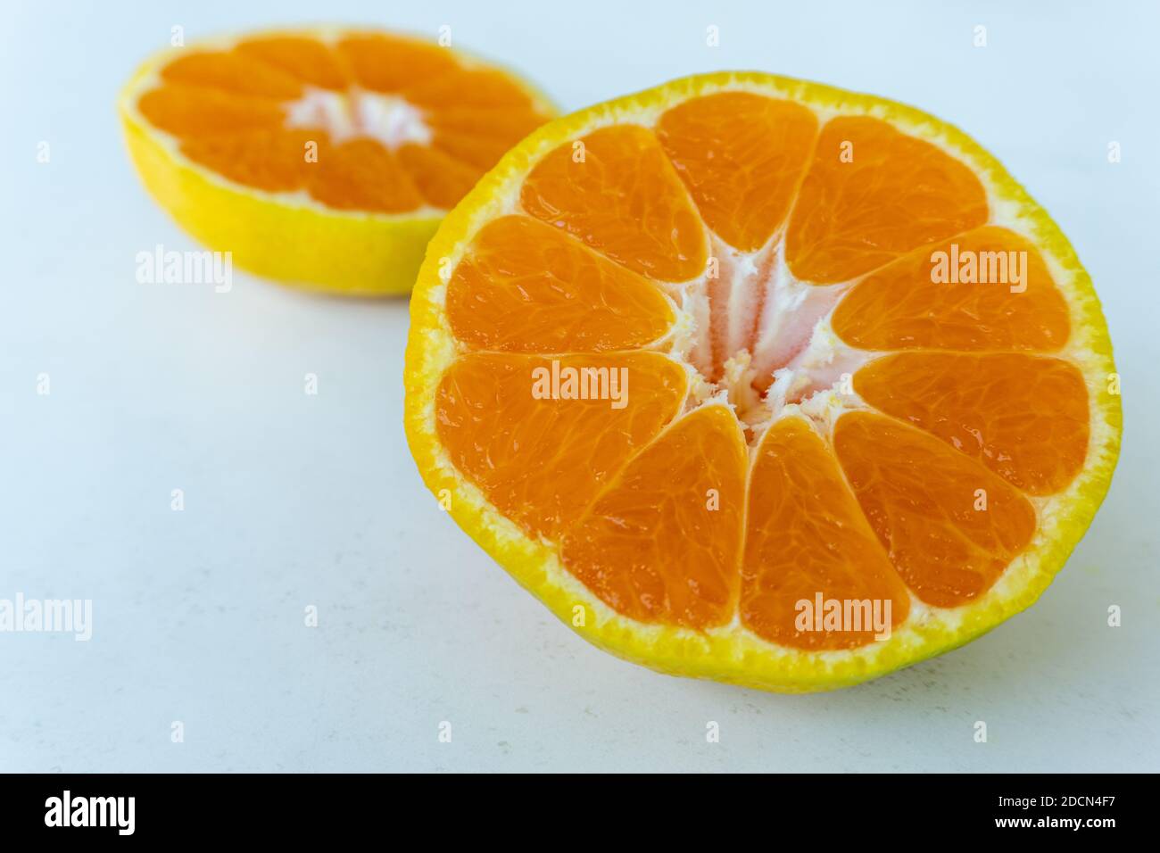 Tangerine cut in half on a white background Stock Photo Alamy