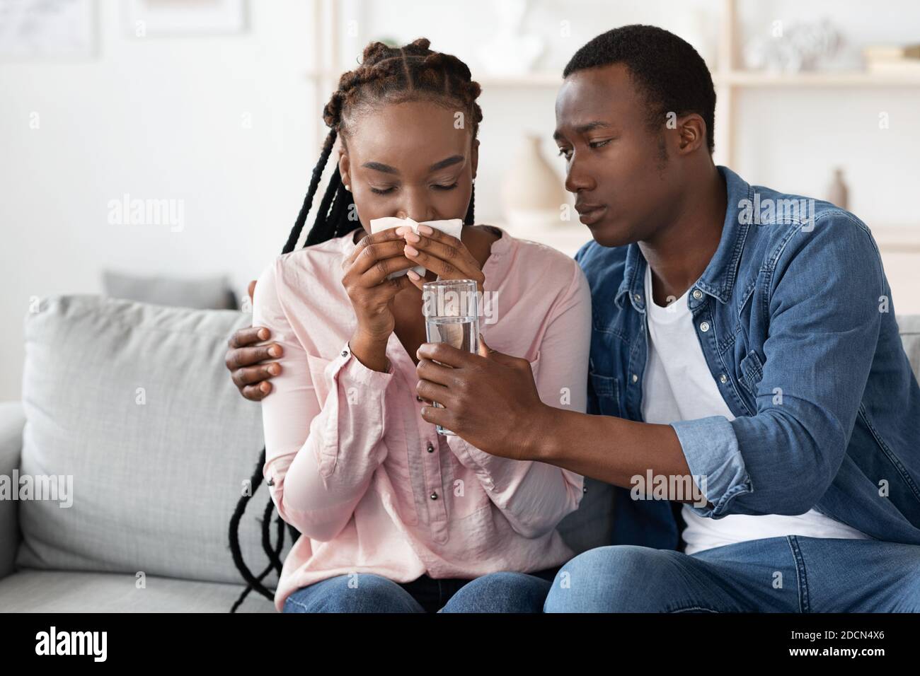 Emotional Breakdown. Caring Black Husband Comforting Crying Wife At Home Stock Photo