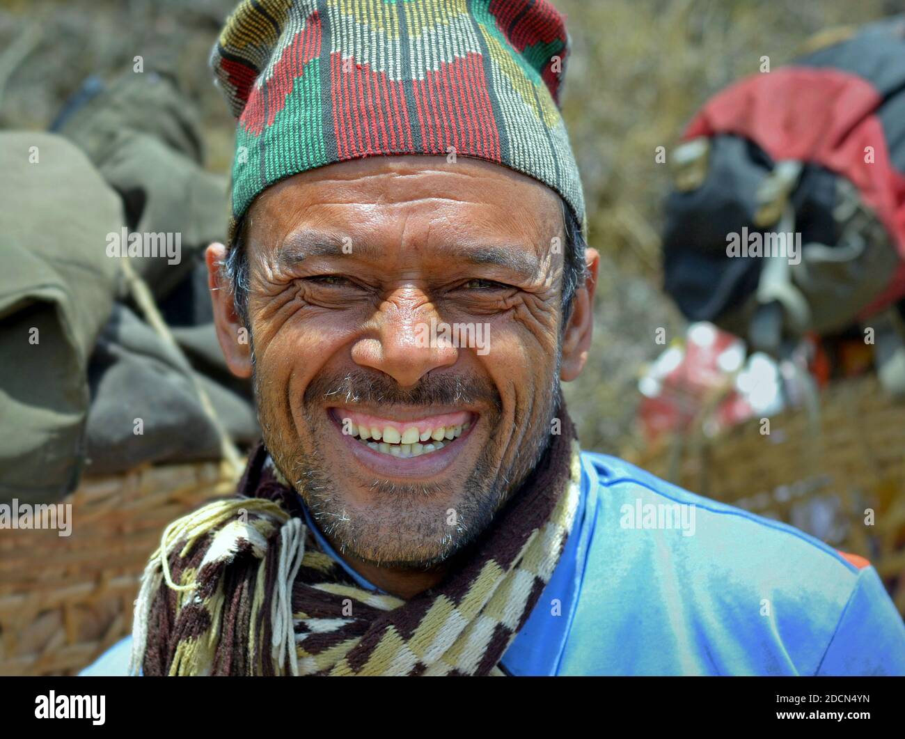Happy middleaged Nepali Chhetri professional mountain porter from the