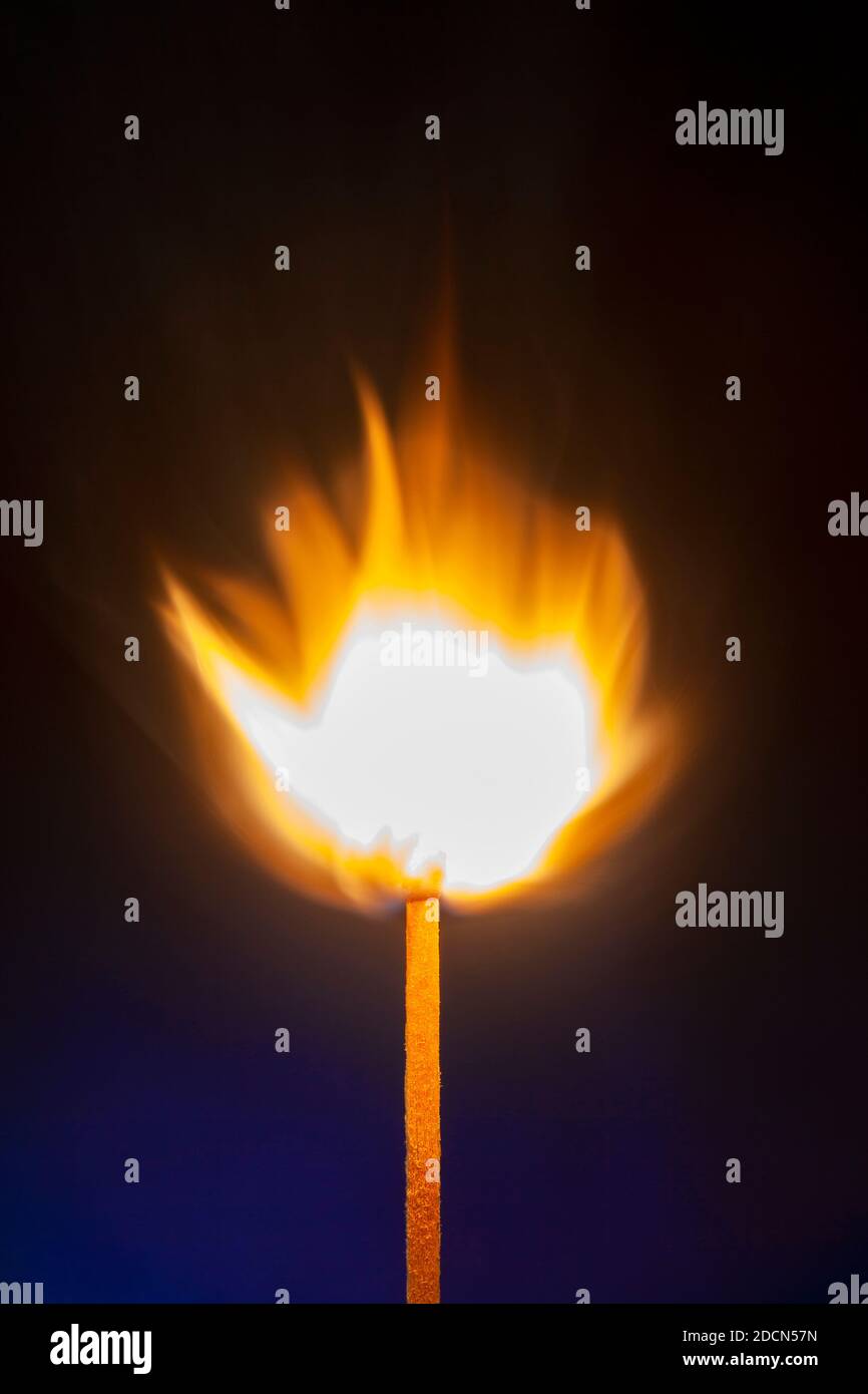 Flame on single matchstick close up with dark background and copy space Stock Photo