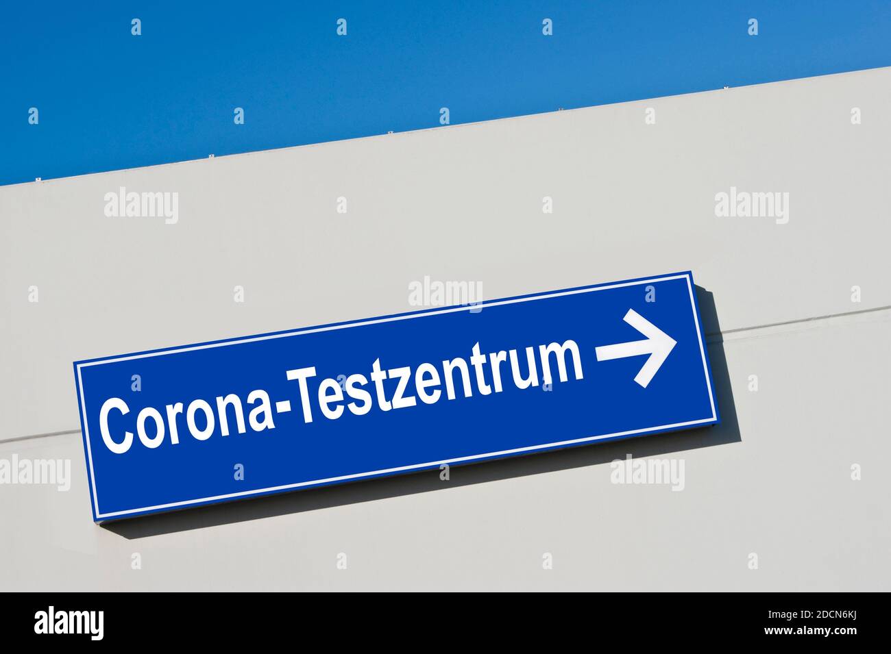German Corona-Testzentrum against blue sign Stock Photo