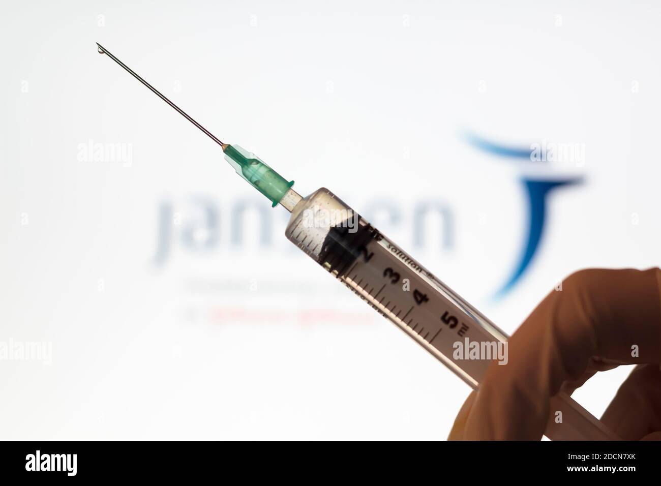 Lisbon, Portugal - November 22, 2020: Syringe and Janssen logo on the background. Coronavirus, Covid-19 vaccine concept Stock Photo