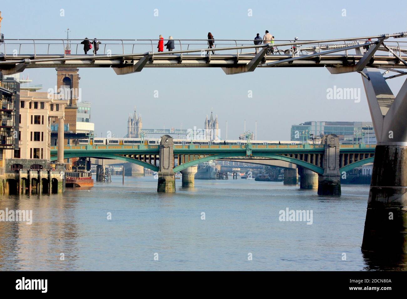 View of Millennium Bridge from the north bank of the River Thames, London Stock Photo