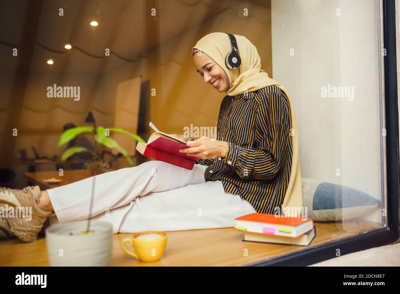 Beautiful arab girl in hijab and headphones Stock Photo Alamy