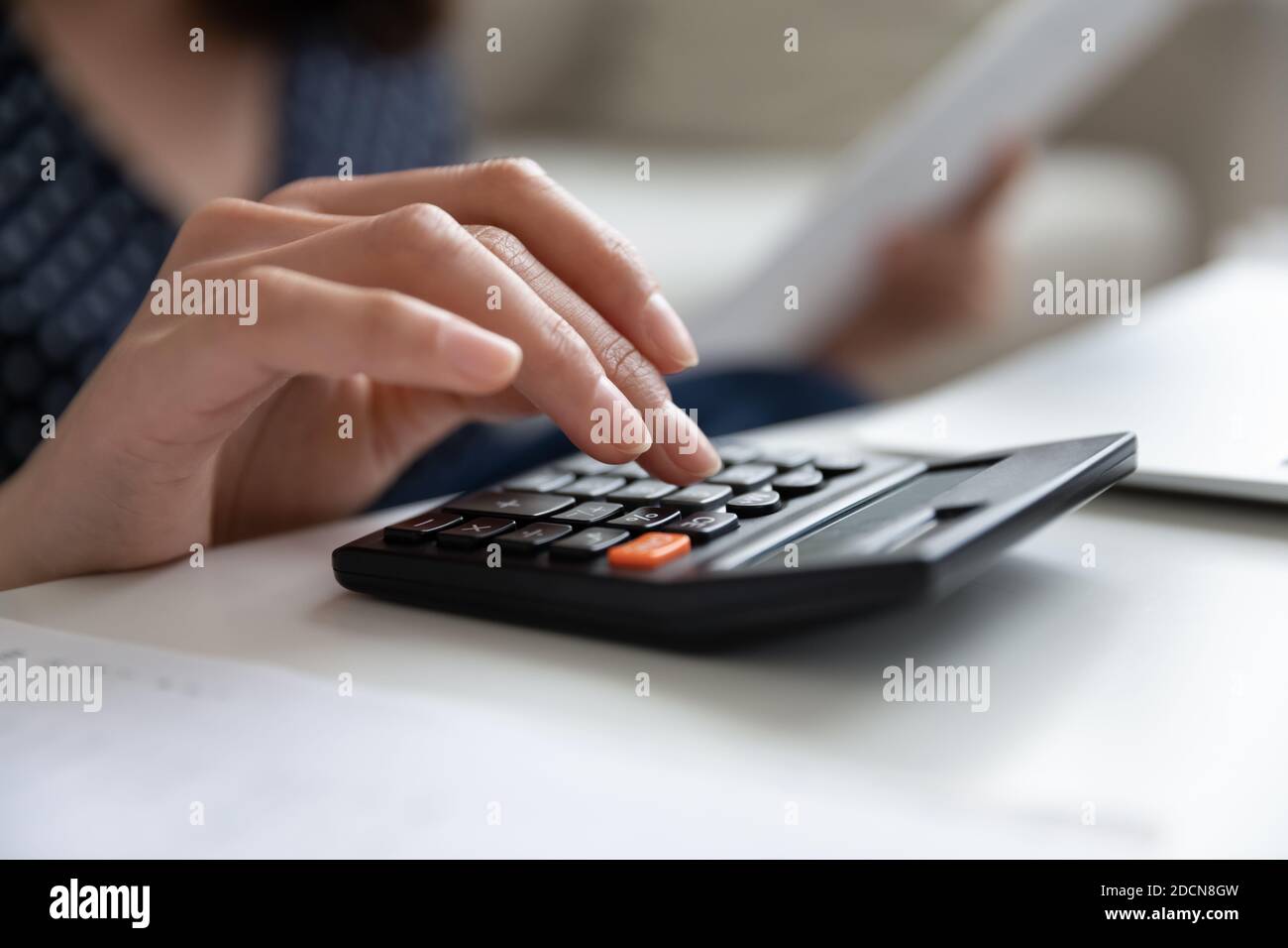 Close up woman using calculator, checking finances, planning budget ...