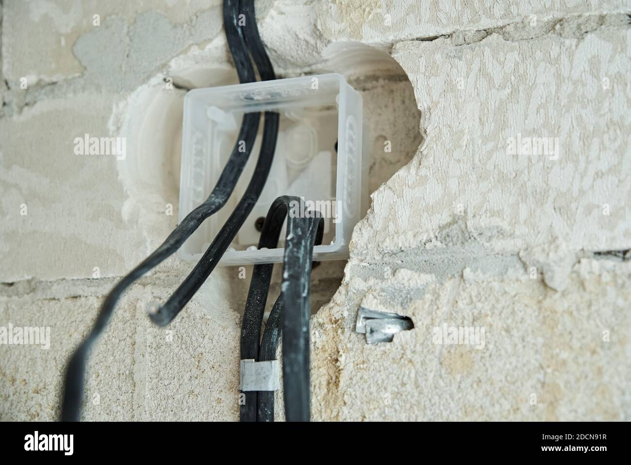 Socket for wiring in concrete wall. Renovation concept Stock Photo - Alamy