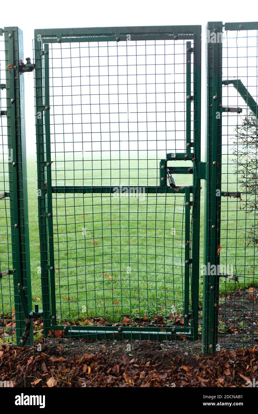 November 2020 - Small side gate into a school field off a pedestrian footway Stock Photo