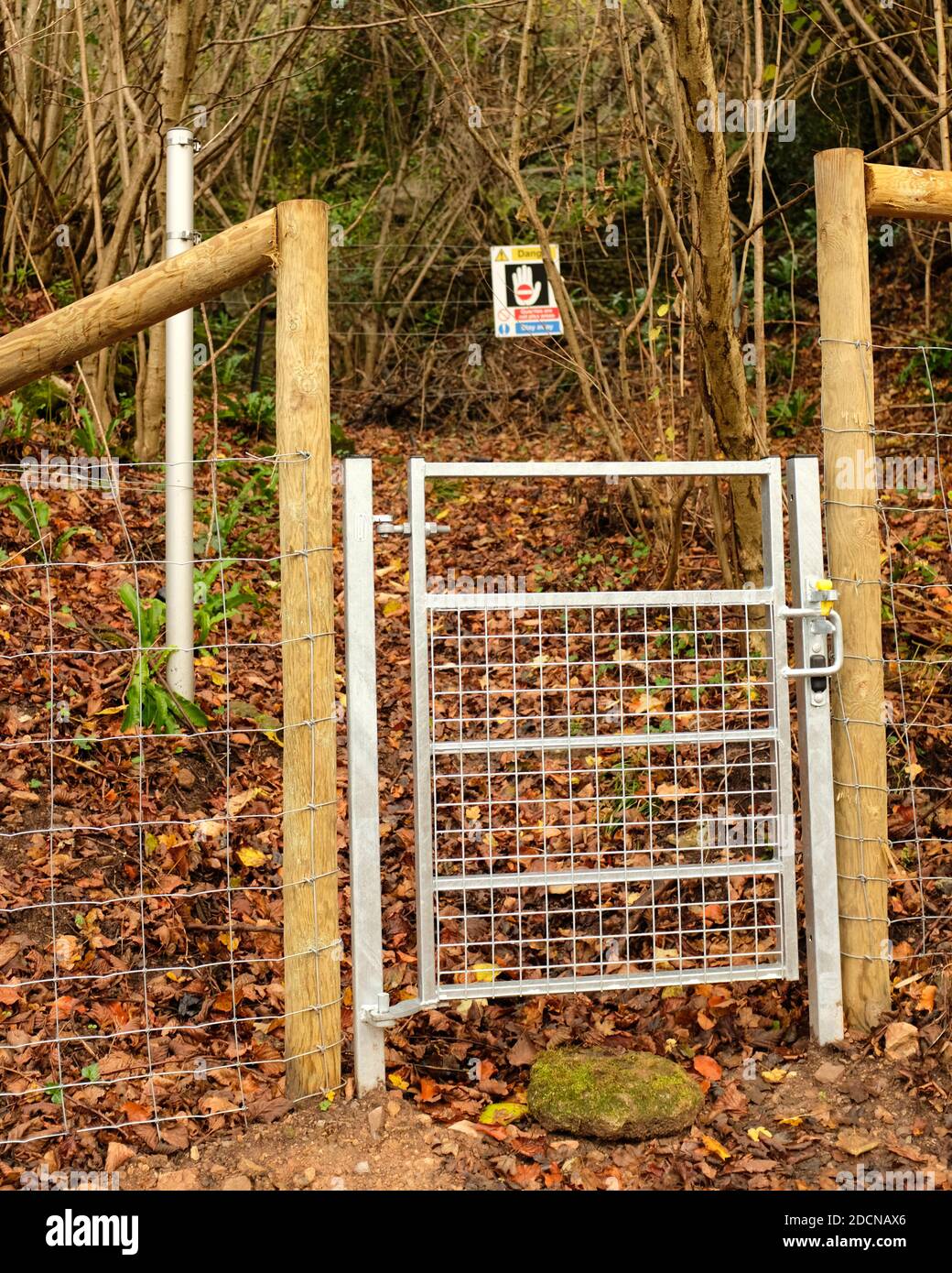 November 2020 - New galvanised metal pedestrian gate on a footpath into the woods Stock Photo