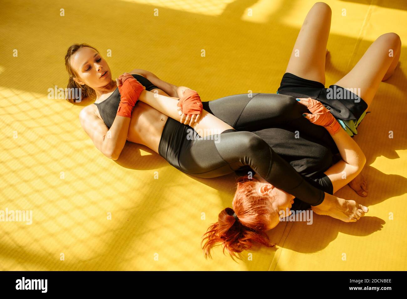 Female MMA fighter performs painful hand grab Stock Photo