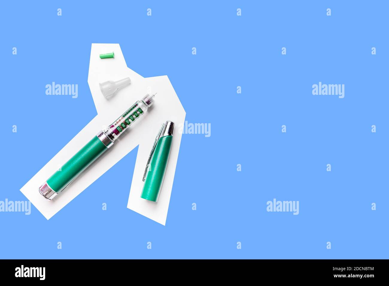 Diabetes green pen injection needle isolated on blue background. Health