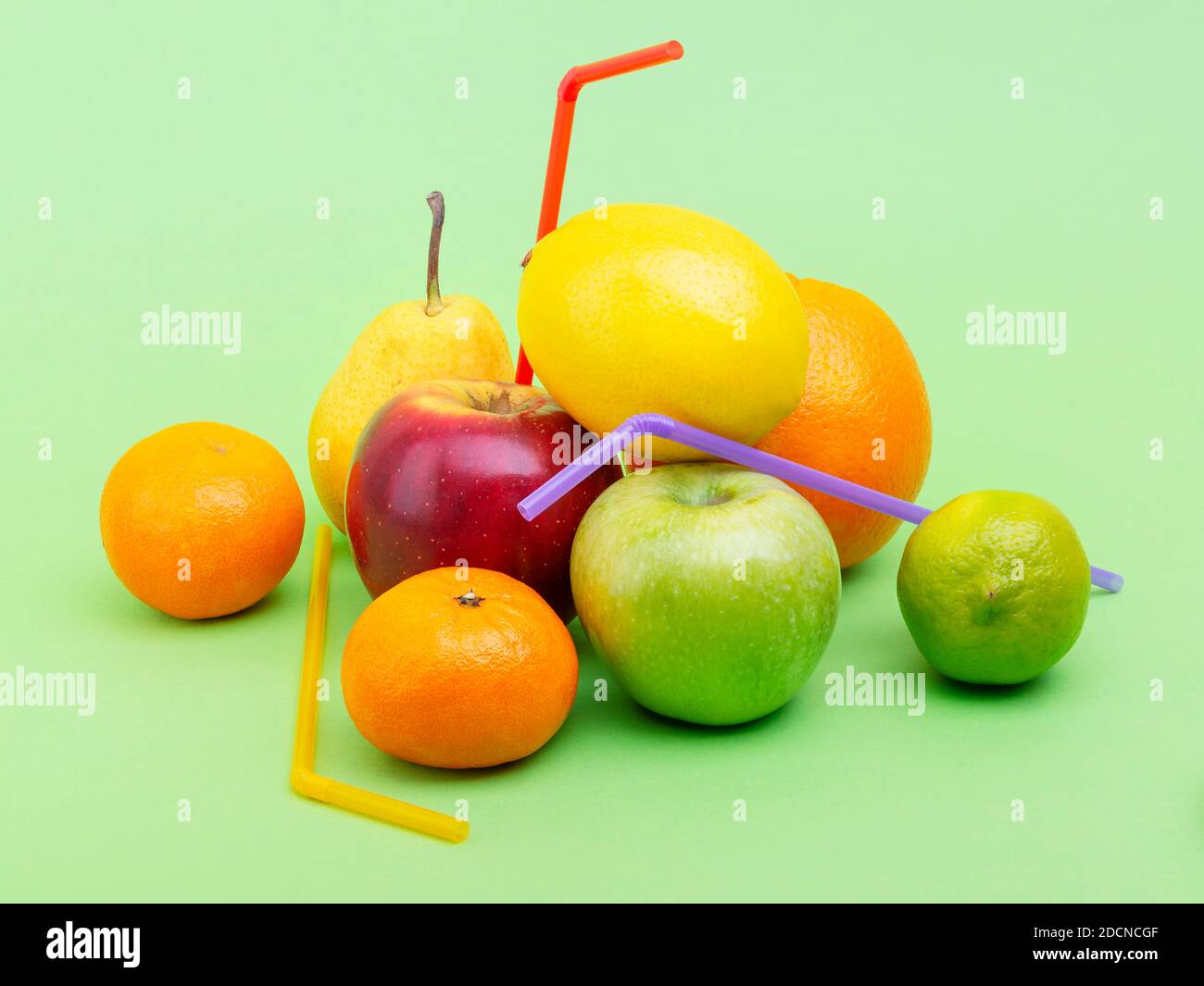 heap of fresh fruits with drinking straw for making juice Stock Photo