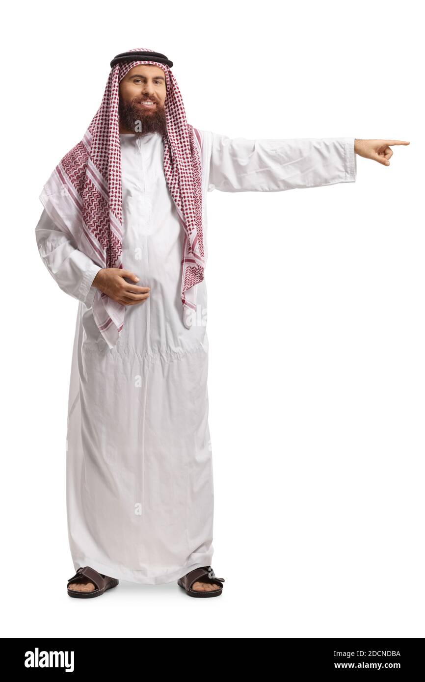 Full length portrait of a saudi arab man wearing a traditional thobe and pointing to the side isolated on white background Stock Photo