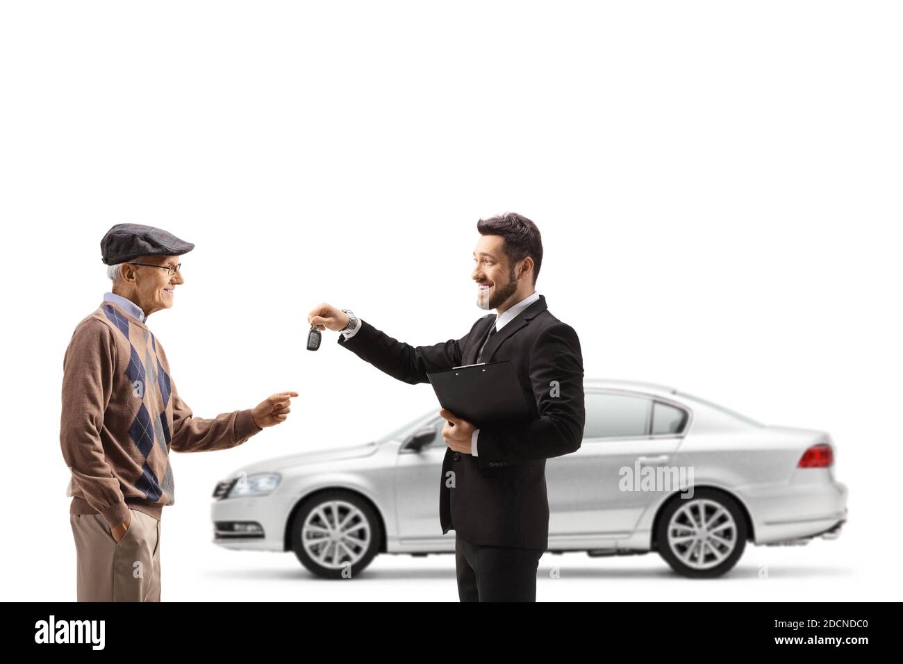 Salesman giving car keys to an elderly customer isolated on white background Stock Photo