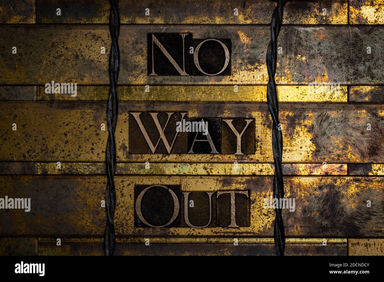 No Way Out text message on textured grunge copper and vintage gold background lined with barbed wire Stock Photo