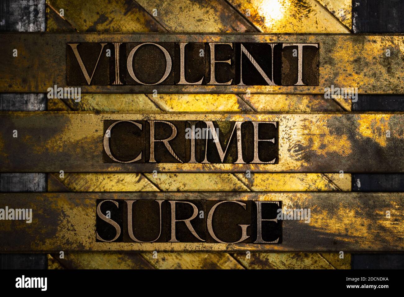 Violent Crime Surge text formed by real authentic typeset letters on vintage textured grunge bronze background Stock Photo