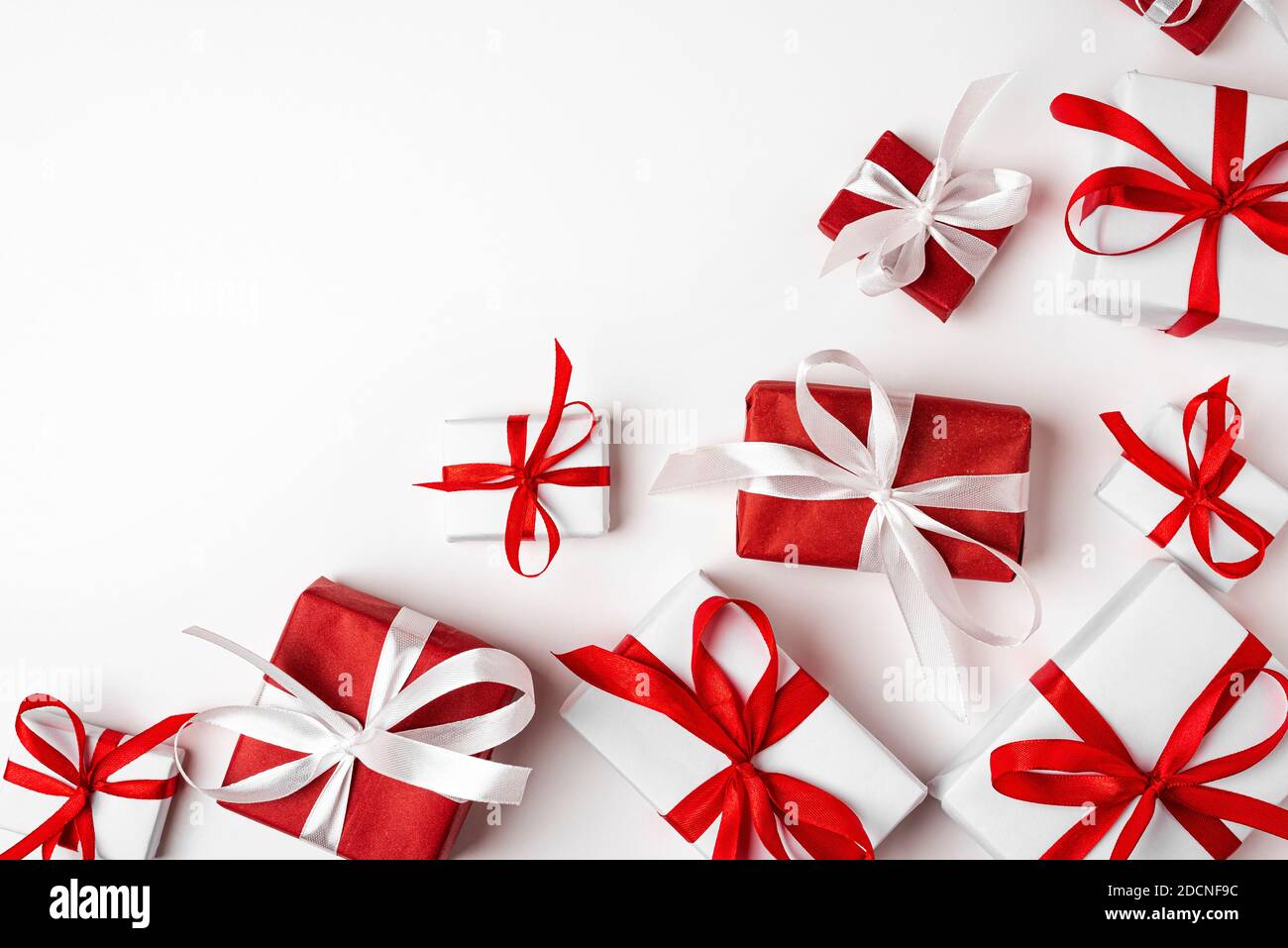 Red and white gift boxes on white background. top view. Happy Holidays. Valentine's day. Birthday. Merry Christmas and Happy New Year Stock Photo