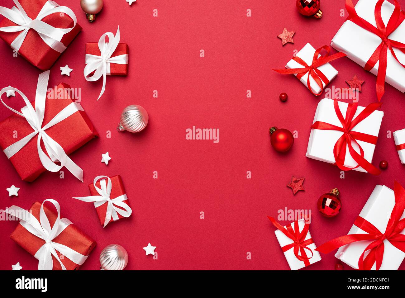 Christmas composition. Merry Christmas and Happy New Year greeting card. Red and white Christmas gift boxes on red background. top view. Winter xmas h Stock Photo