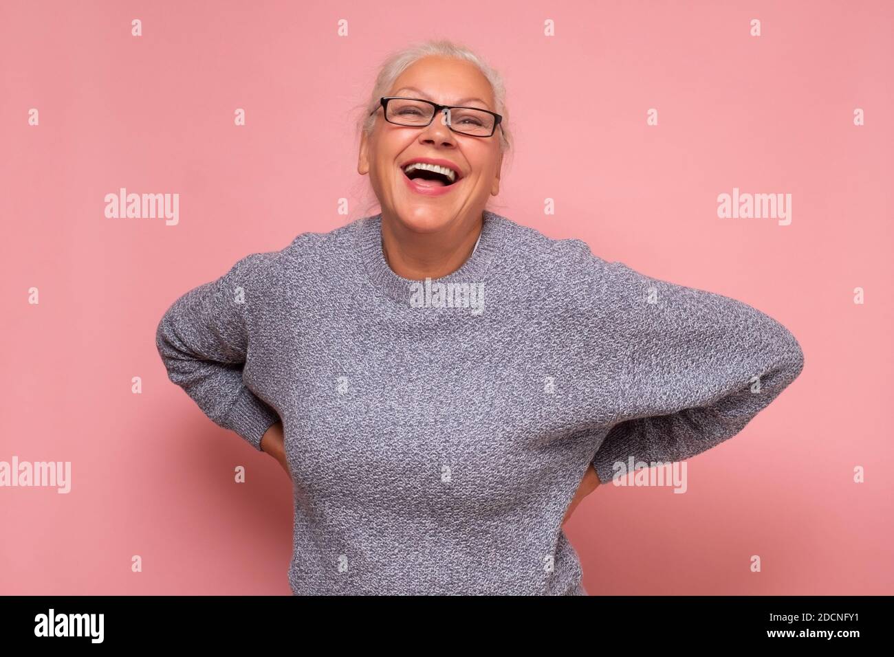 Middle age caucasian woman smiling and laughing hard out loud because funny joke. Studio shot Stock Photo