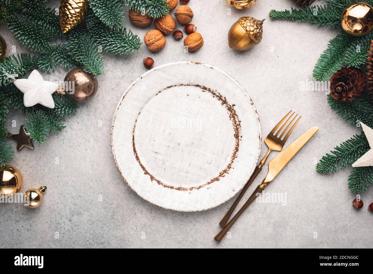 Modern Christmas Table Setting With Empty Plate And Cutlery. Top view, Copy Space For Design Or Text. Toned image Stock Photo