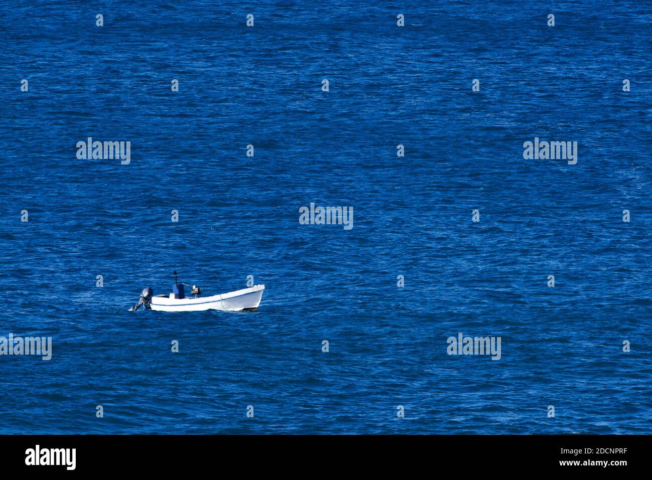 White fishing boat on the blue sea Stock Photo - Alamy