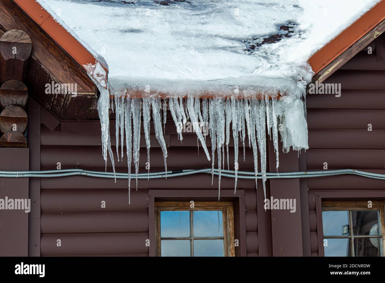 Roof covered by ice and snow on blue sky background, mountain Zakhar Berkut, Carpathian mountains, Ukraine Stock Photo