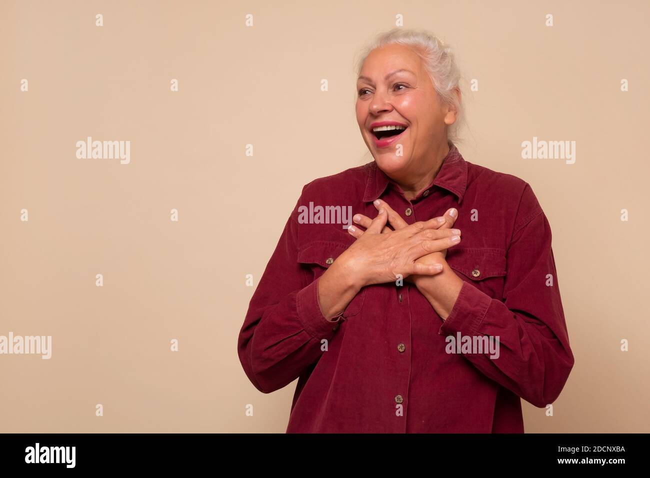 Old hispanic woman with surprised expression on her face Stock Photo