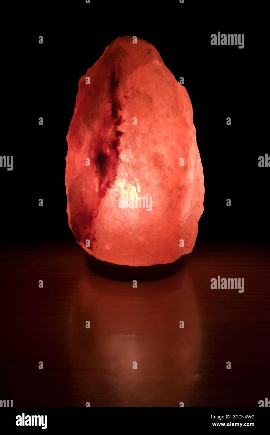 Himalayan Salt Lamp on black background. Stock Photo