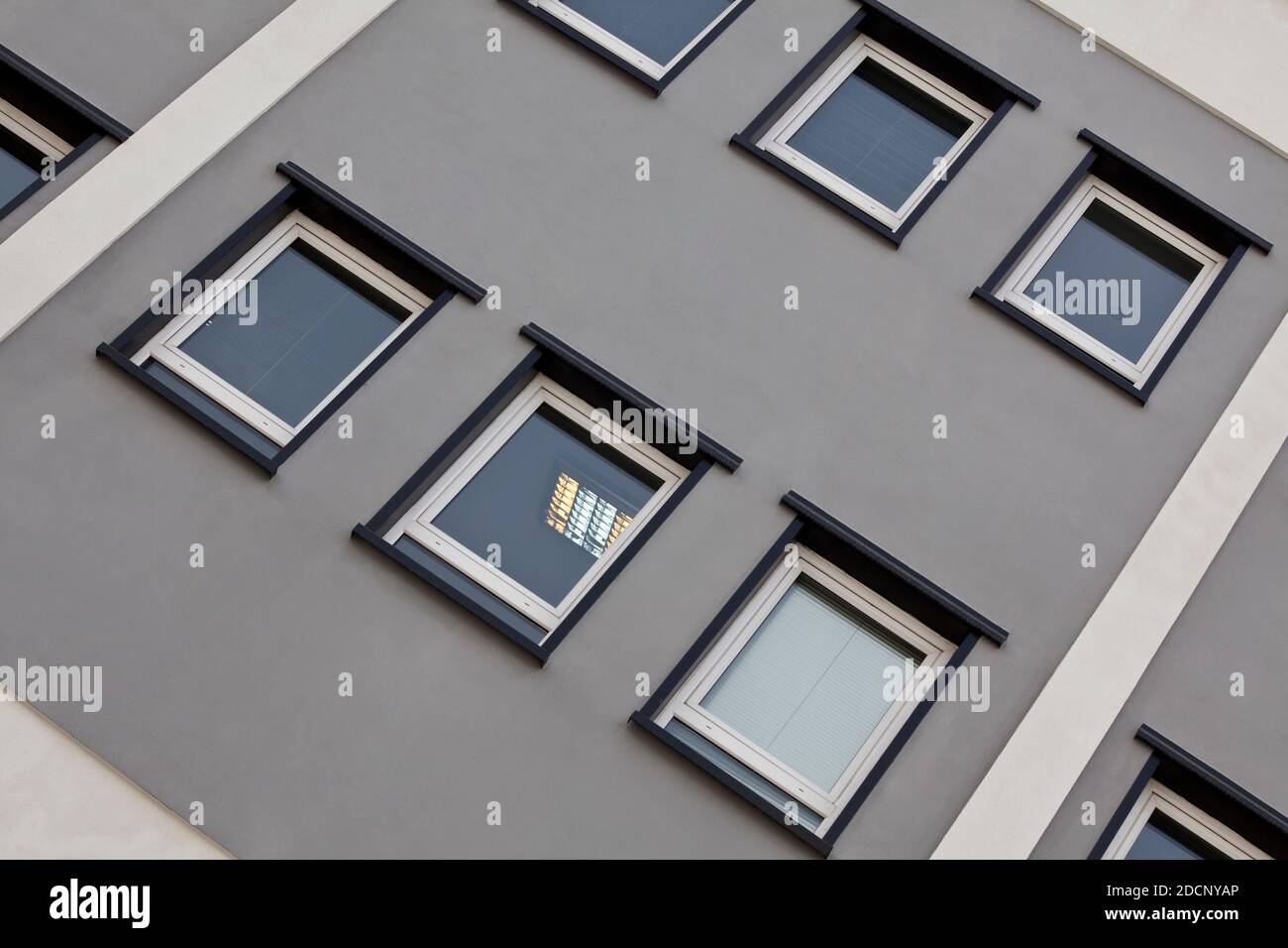 Building facade with square windows and sky Stock Photo - Alamy