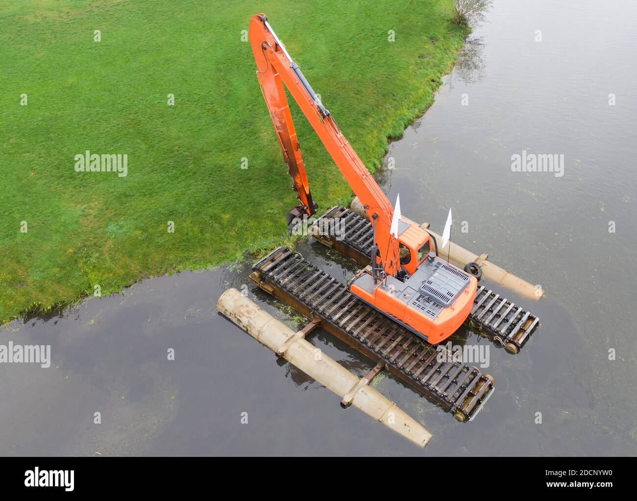 Floating excavator for cleaning ponds, aerial view. Provision of water