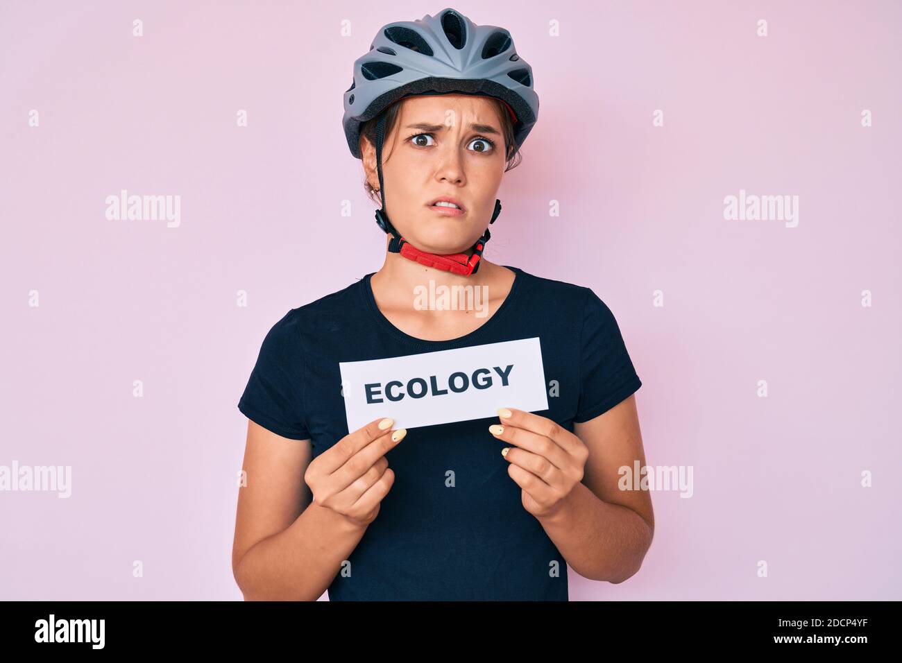 Beautiful Caucasian Woman Wearing Bike Helmet Holding Ecology Word beautiful-caucasian-woman-wearing-bike-helmet-holding-ecology-word