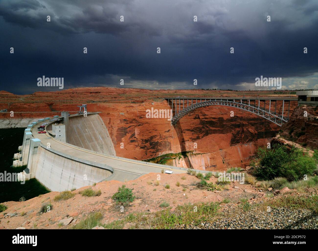 Glen Canyon Dam And Glen Canyon Dam Bridge Spanning The Colorado River On A Hot Sunny Summer Day With A Thunderstorm Approaching Stock Photo