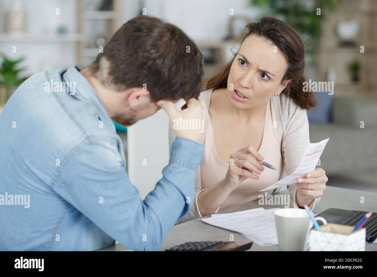 woman confronting her partner over a receipt Stock Photo