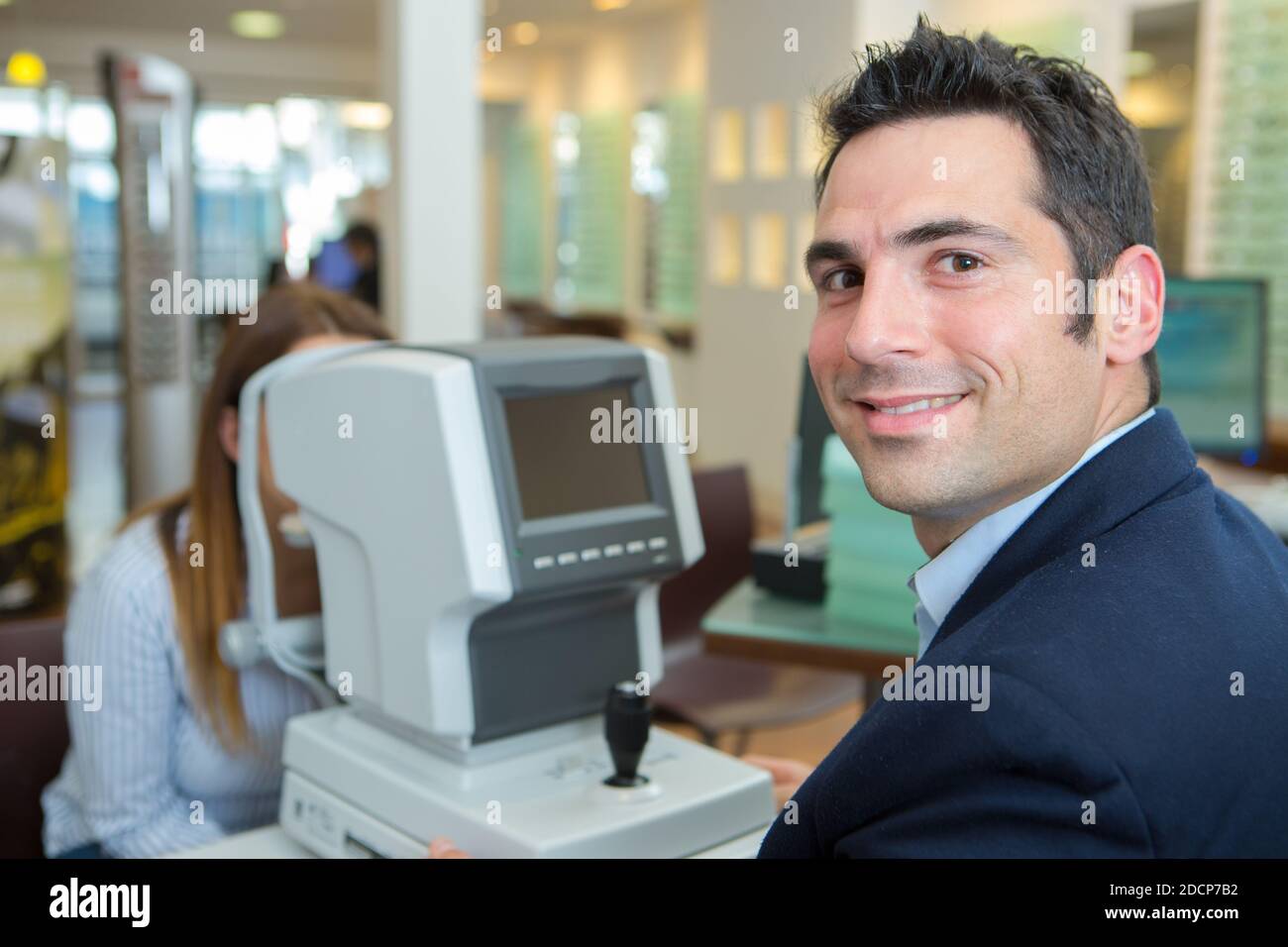 optician checking clients eyes using phoropter Stock Photo Alamy