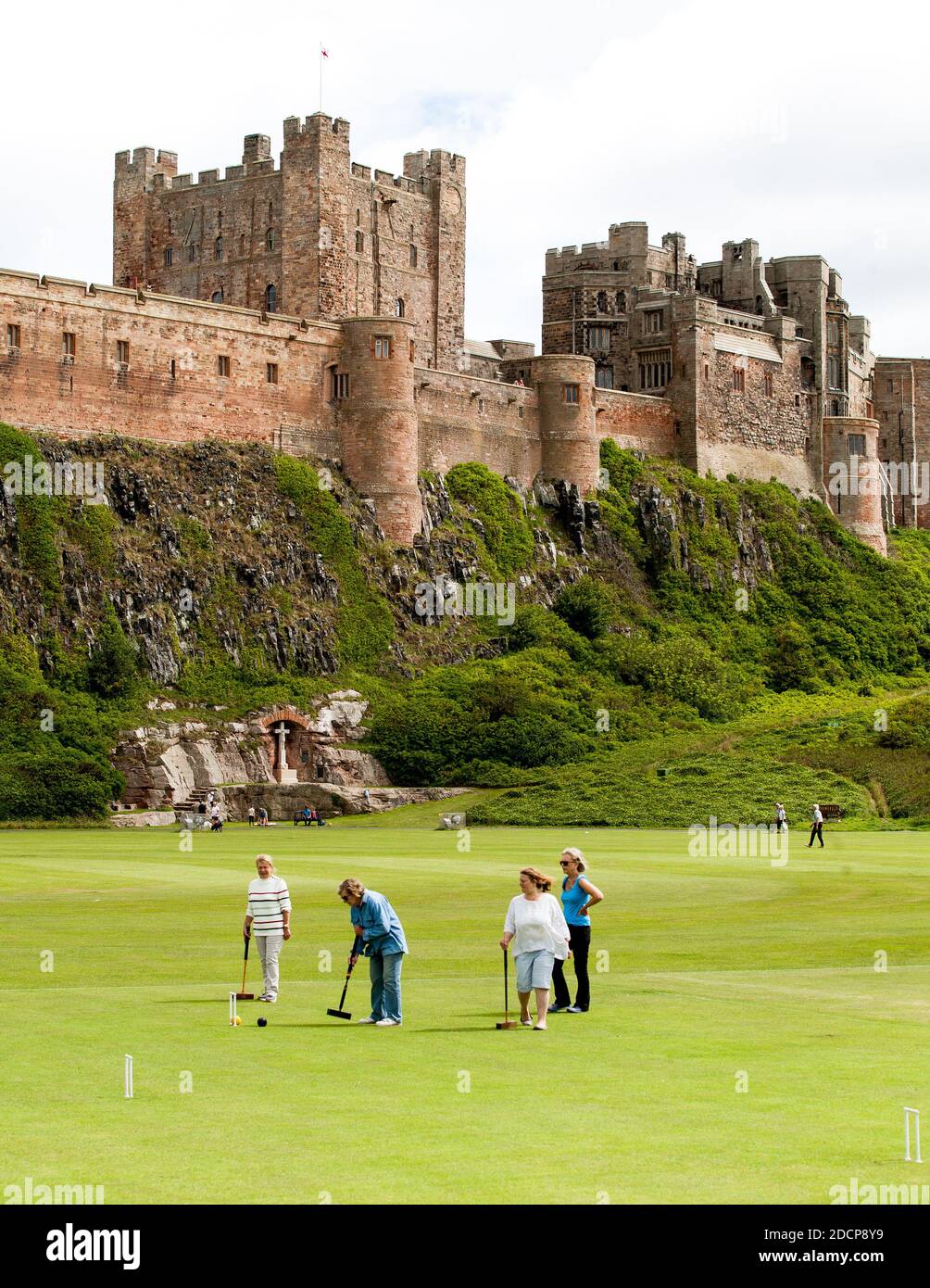 Bamburgh, Northumberland, England - July 16th 2020: Traditional English game of croquet played with the backdrop of Bamburgh Castle, Northumberland. Stock Photo