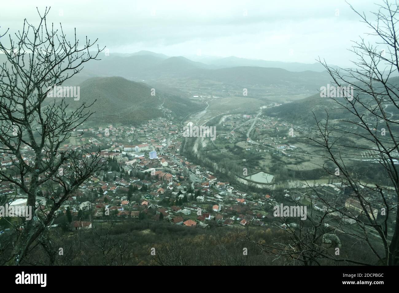 Panorama of the city of Zvecan, in the northern part of Kosovo, with a serb majority of population, in winter, with the mountain range of Ibarski Kola Stock Photo