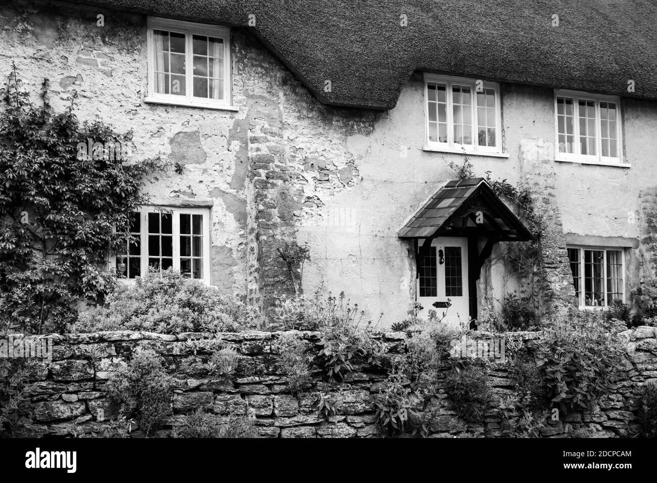 Close up of the Tellis Farm house, a thatched roof home of historical significance in the village of East Cocker, Somerset, England, in black and whit Stock Photo