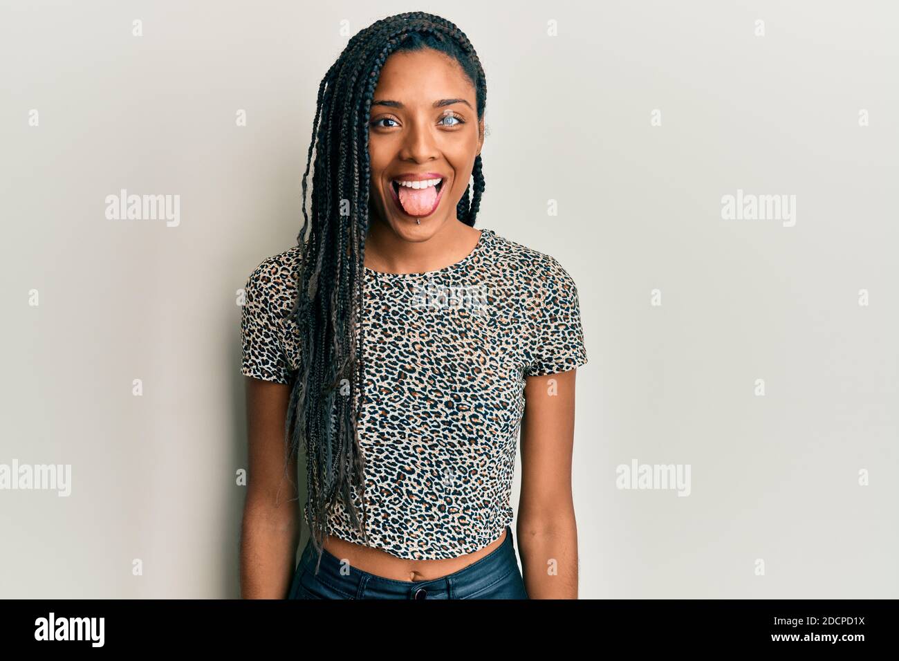 African american woman wearing casual clothes sticking tongue out happy ...