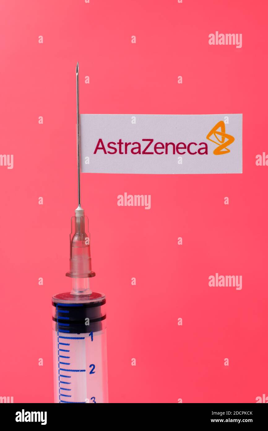 Stafford / United Kingdom - November 22 2020: AstraZeneca Oxford vaccine Covid-19 concept. Syringe needle and sticker on it, blurred background. Real Stock Photo