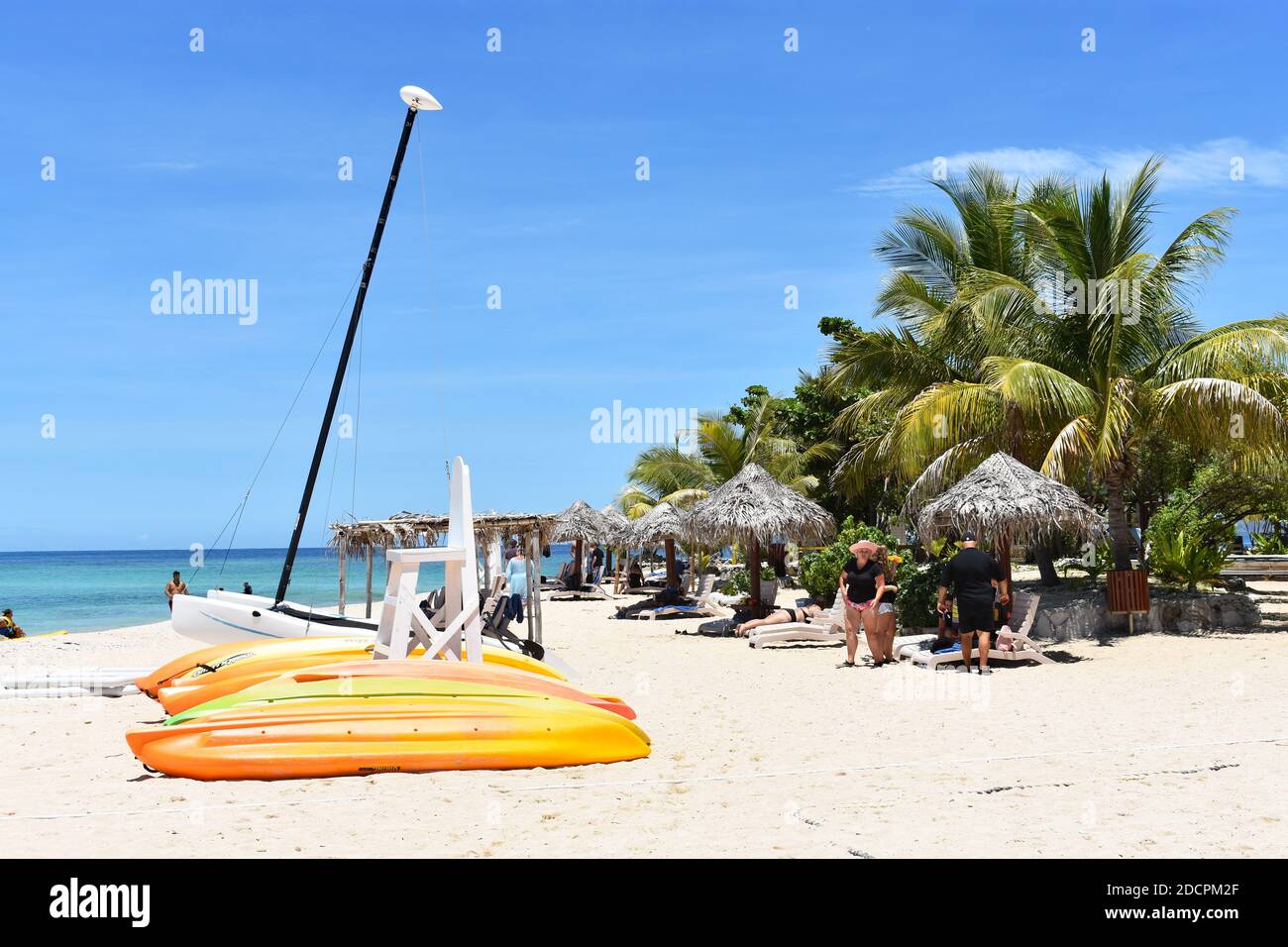 South Sea Island is a popular island located in the Mamanuca Islands, Fiji. Yellow kayaks are laid out on the white sand beach lined with palm trees. Stock Photo