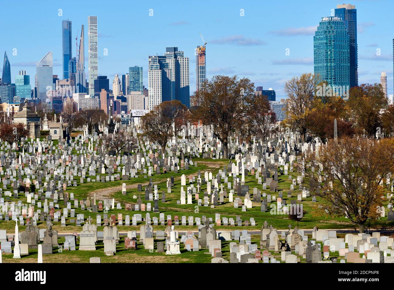 Queens, NY - November 16 2020: Cavalry Cemetery in Queens, NYC in front of the skyline of Midtown Manhattan. Calvary Cemetery has the largest number o Stock Photo