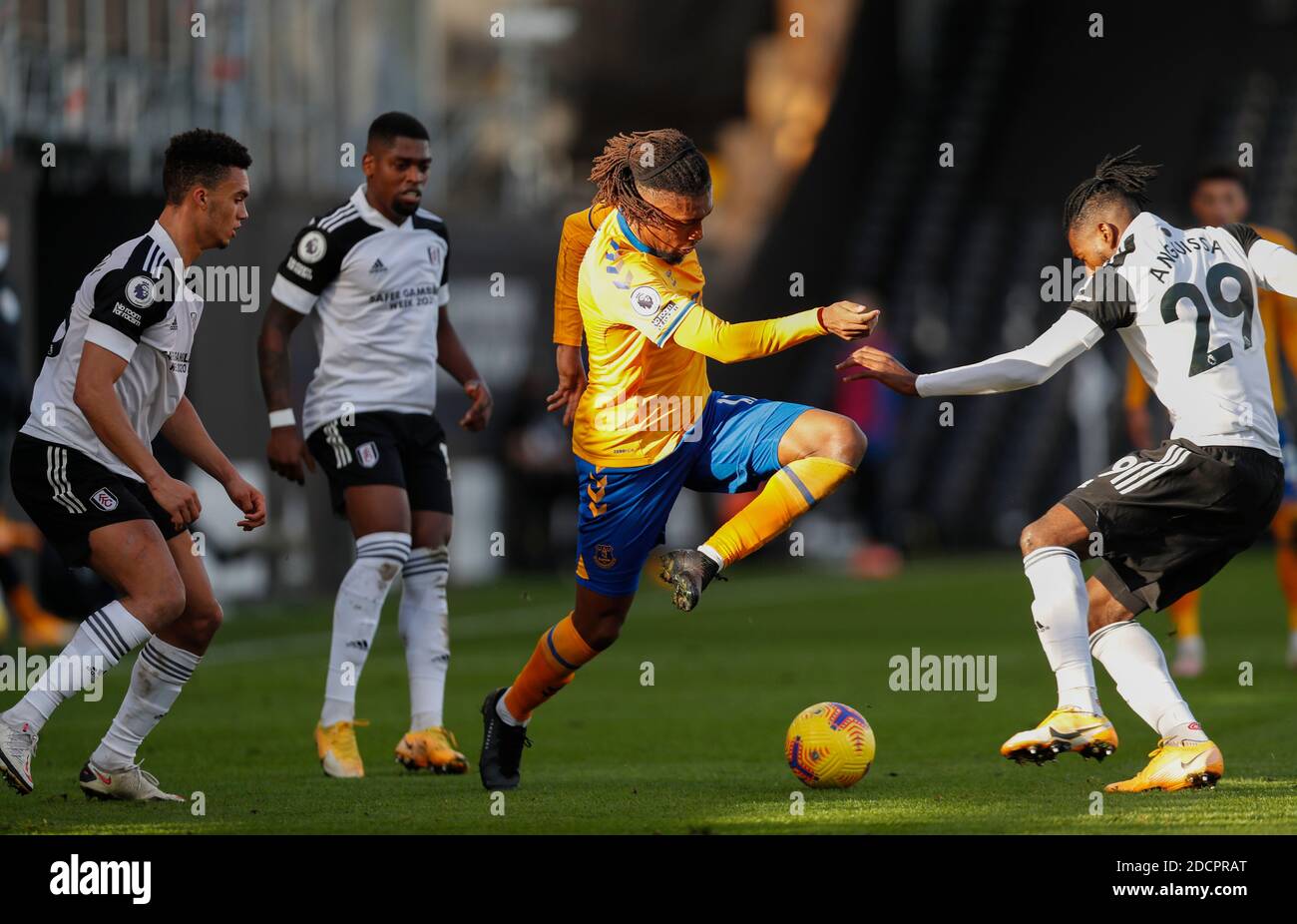 London, Britain. 22nd Nov, 2020. Everton's Alex Iwobi (2nd R) vies with Fulham's Andre-Frank Zambo Anguissa (1st R) during the English Premier League between Fulham and Everton in London, Britain, Nov. 22, 2020. Credit: Han Yan/Xinhua/Alamy Live News Stock Photo