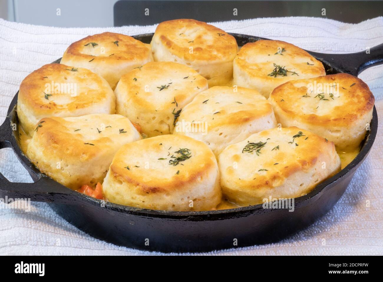 Chicken pot pie with biscuits used on top cooked to a toasty golden brown in a cast iron skillet. Stock Photo